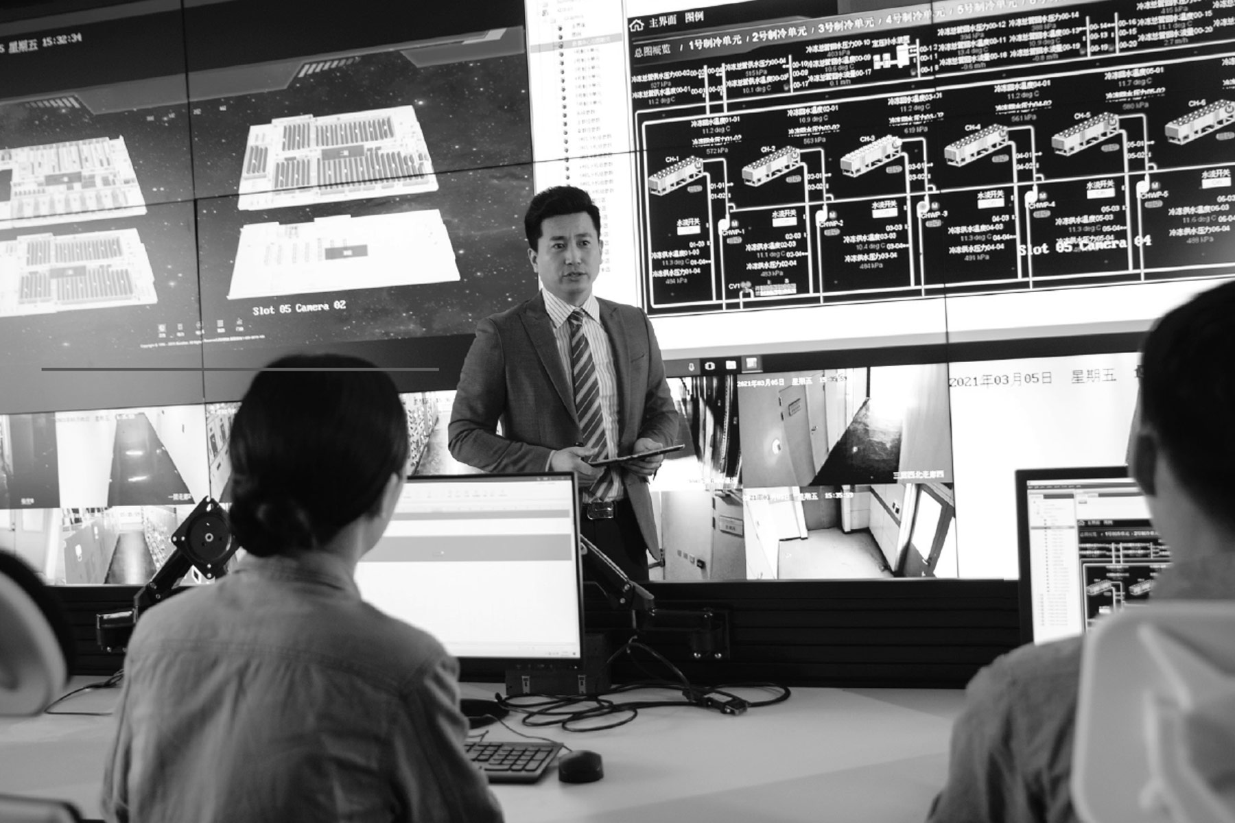 man in front of computers and a team of data science professionals